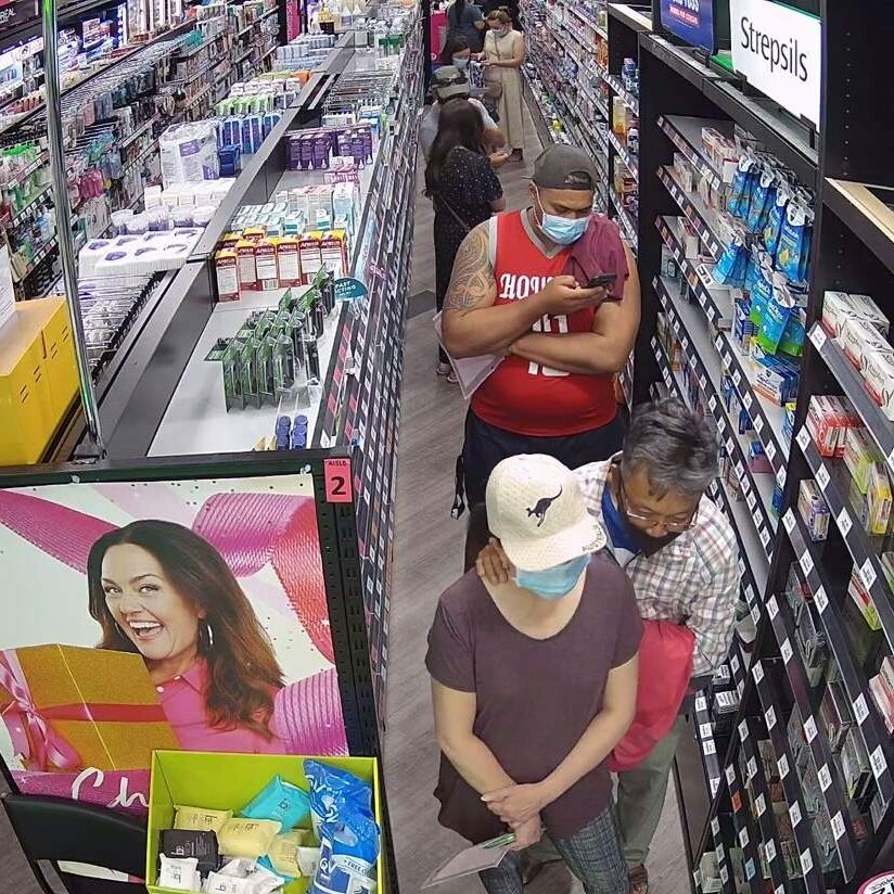 A queue of masked customers at a Sydney pharmacy.