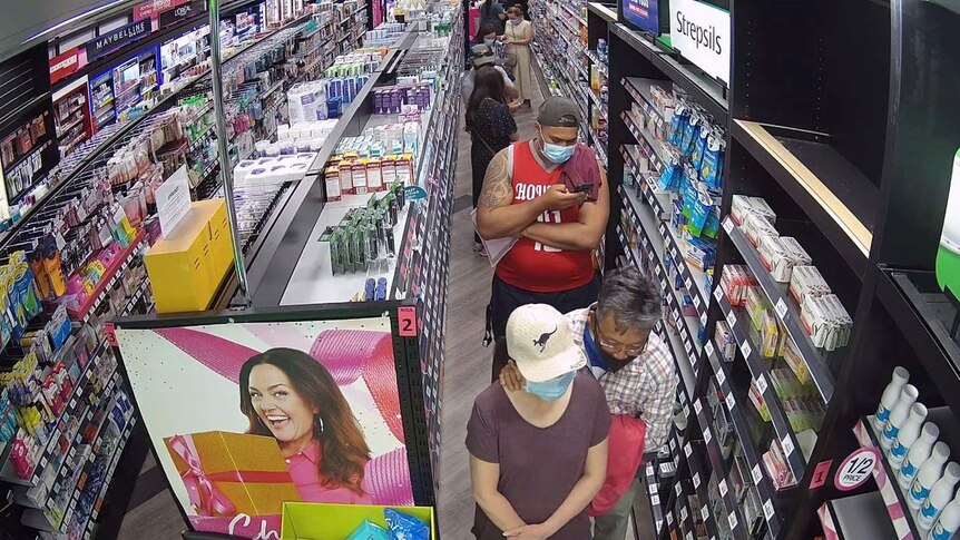 A queue of masked customers at a Sydney pharmacy.