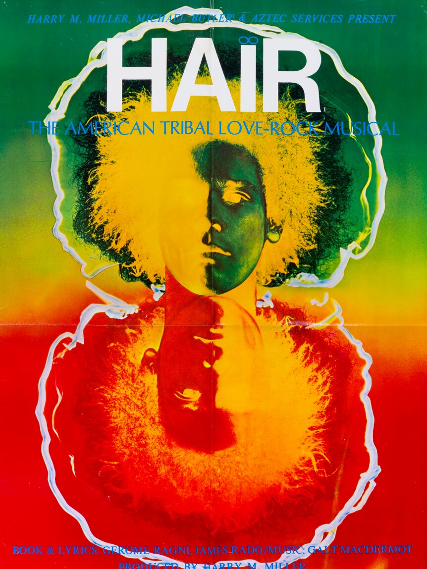 A psychedelic poster for the 1969 musical hair, with two faces, one red and yellow, one green and yellow