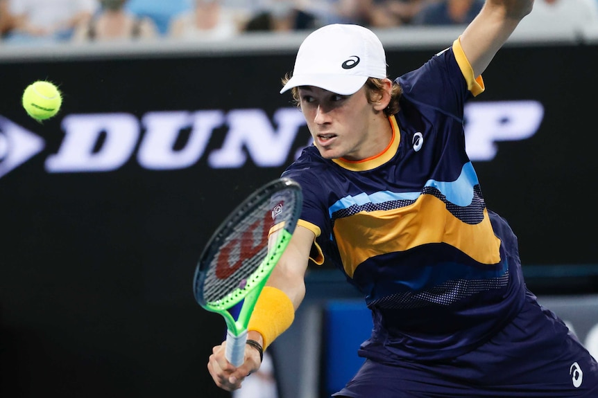 Alex de Minaur plays a one-handed backhand at the Australian Open.