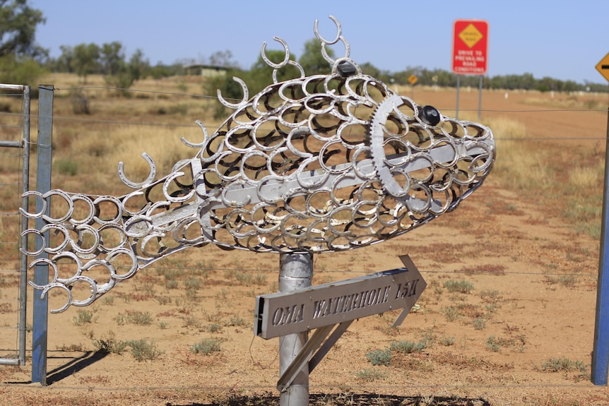 A silver yellowbelly sculpture made out of horseshoes.