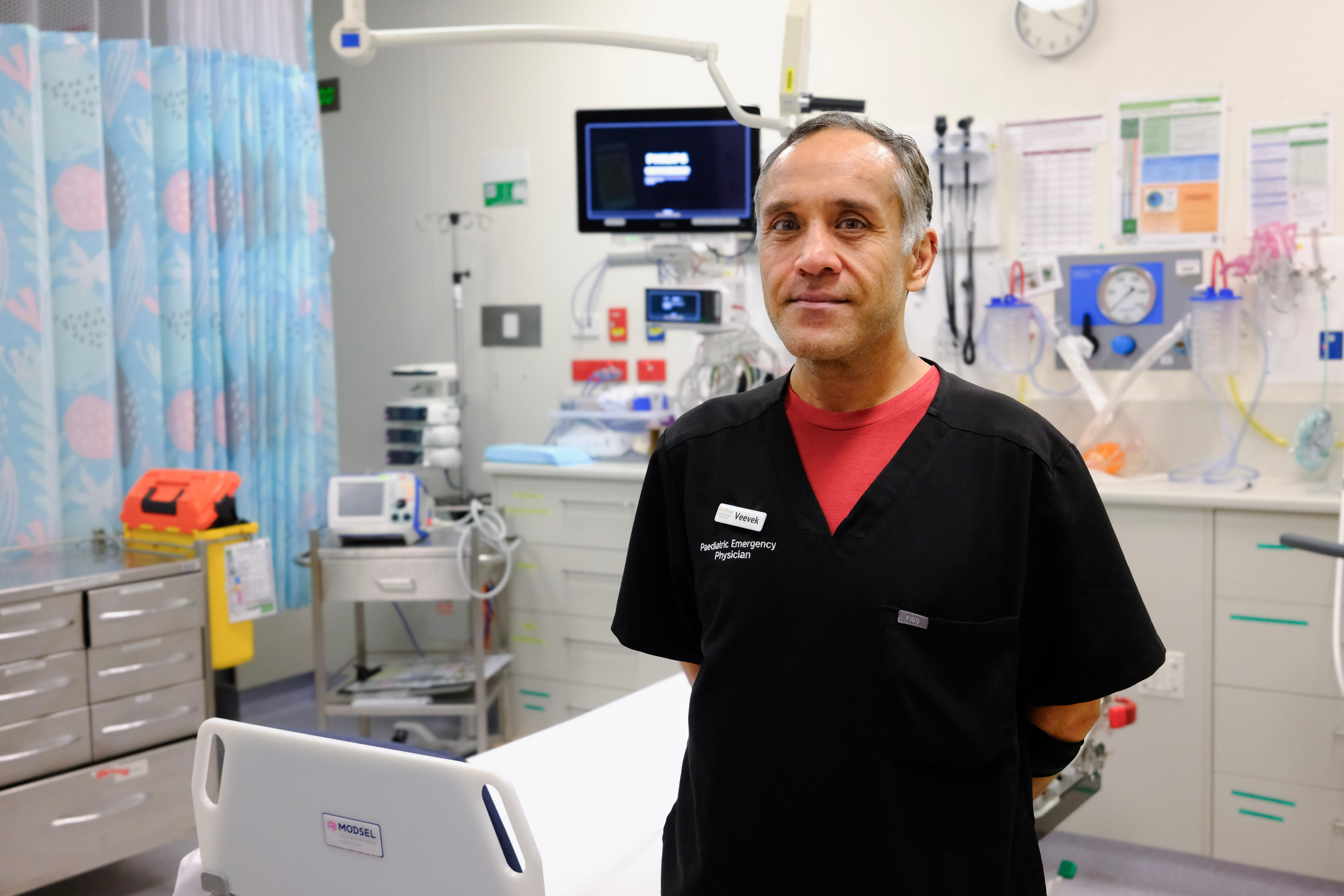 Dr Veevek Thankey standing in a hospital room.