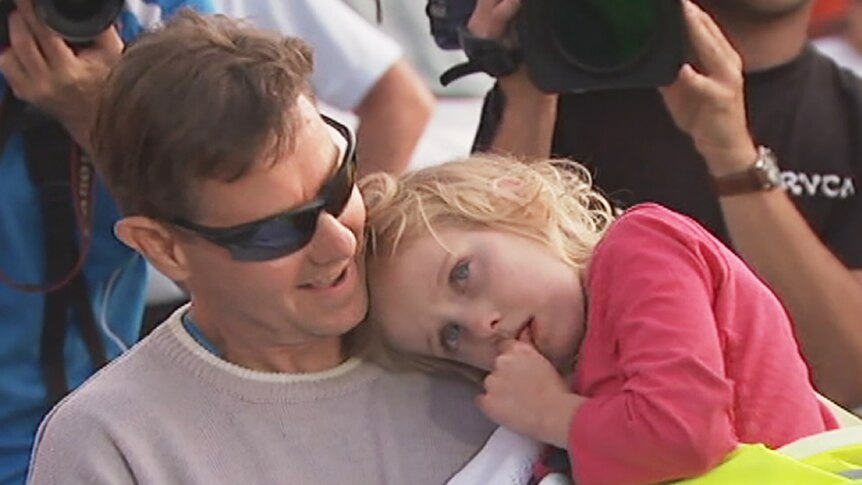 Five-year-old Jocelyn has her head on the shoulder of her father Steve Lewis