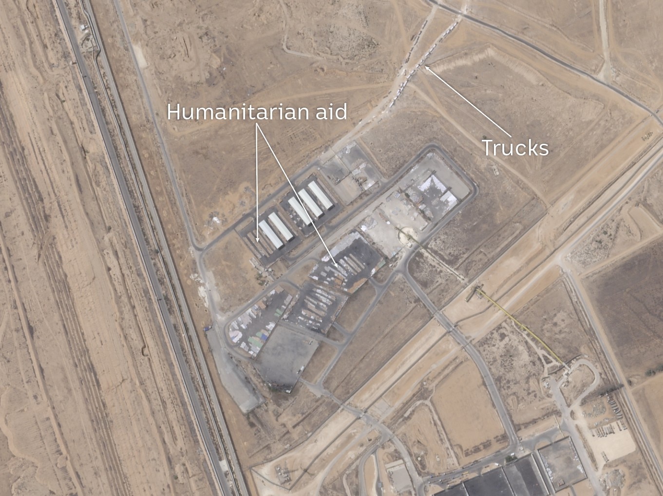 Satellite imagery of what looks like warehouses and an area with aid stacked