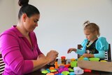 A mother and daughter enjoying playing playdough together