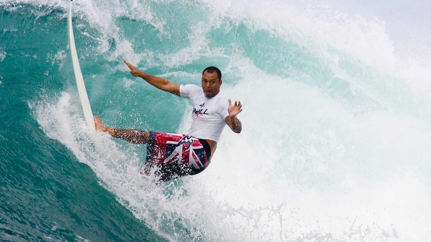 Close in shot of a surfer attempting to navigate a wave.