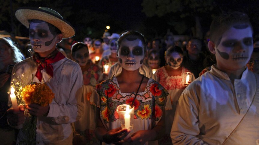 People, with their faces painted as skulls, take part in a traditional parade called "Paseo de las Animas", or Parade of Souls, as part of Day of the Dead celebrations in Merida, Mexico, October 31, 2015