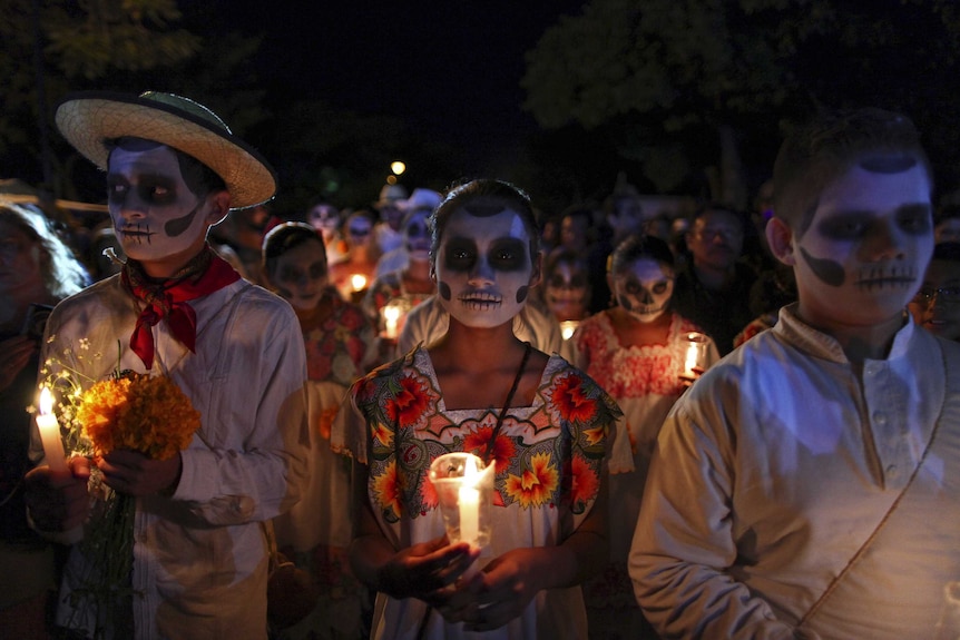 People, with their faces painted as skulls, take part in a traditional parade called "Paseo de las Animas", or Parade of Souls, as part of Day of the Dead celebrations in Merida, Mexico, October 31, 2015