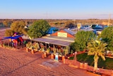 A pub surrounded by red dirt in the desert