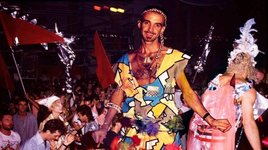 A young man in an outlandish outfit at a party in the 1980s.