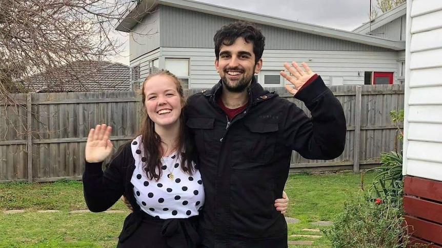 Woman and man waving in a yard, in a story about tips for securing a rental property in a competitive market.