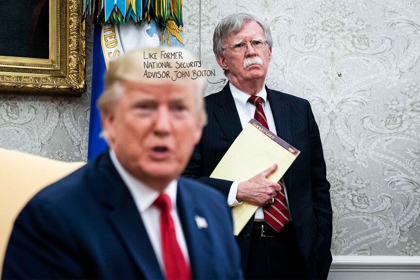 John Bolton, the former National Security Advisor stands behind Donald Trump. He is one of the new witnesses.