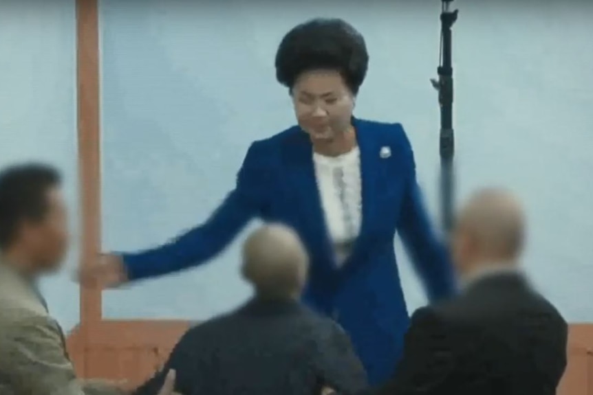 Shin Ok-ju slaps one of her followers in this screencap of footage aired by the Seoul Broadcasting System (SBS).
