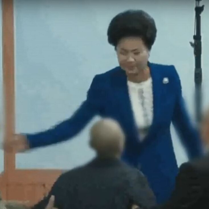 Shin Ok-ju slaps one of her followers in this screencap of footage aired by the Seoul Broadcasting System (SBS).