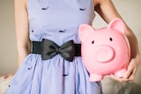 Woman holding a piggy bank