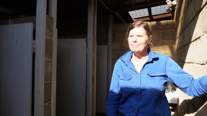 A woman in a toilet block 