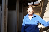 A woman in a toilet block 