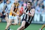 Collingwood's Dale Thomas with the ball