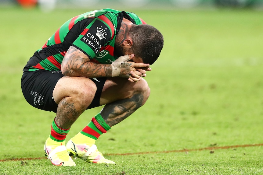 Rugby league player with his head in his hands after losing the grand final