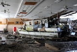 A damaged boat sits inside a building in Pago Pago on American Samoa