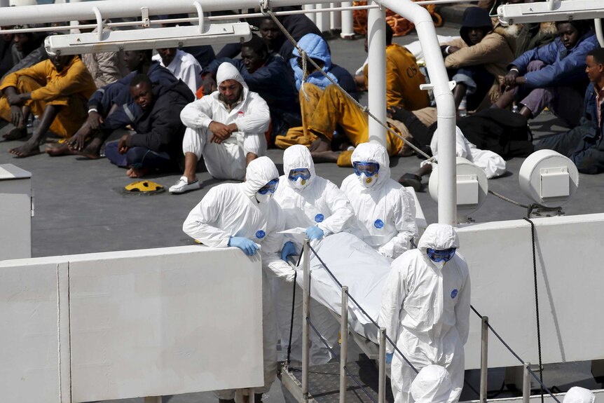 Malta personnel carry body of dead immigrant