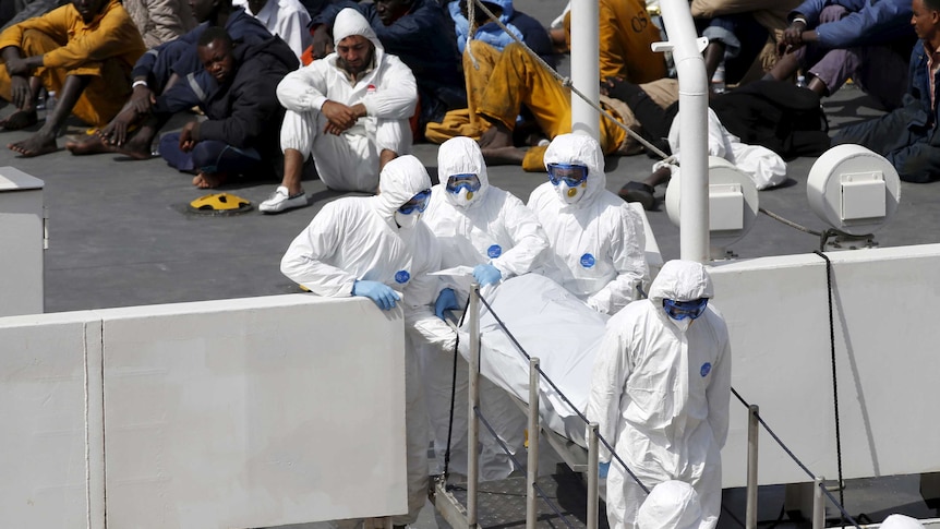 Malta personnel carry body of dead immigrant