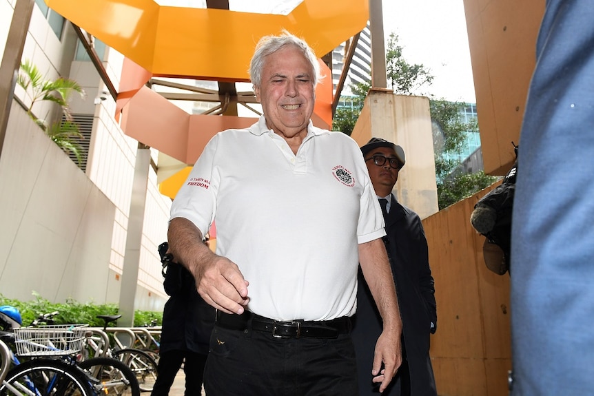 Businessman and former federal MP Clive Palmer (left) grimaces as he leaves the Federal Court in Brisbane