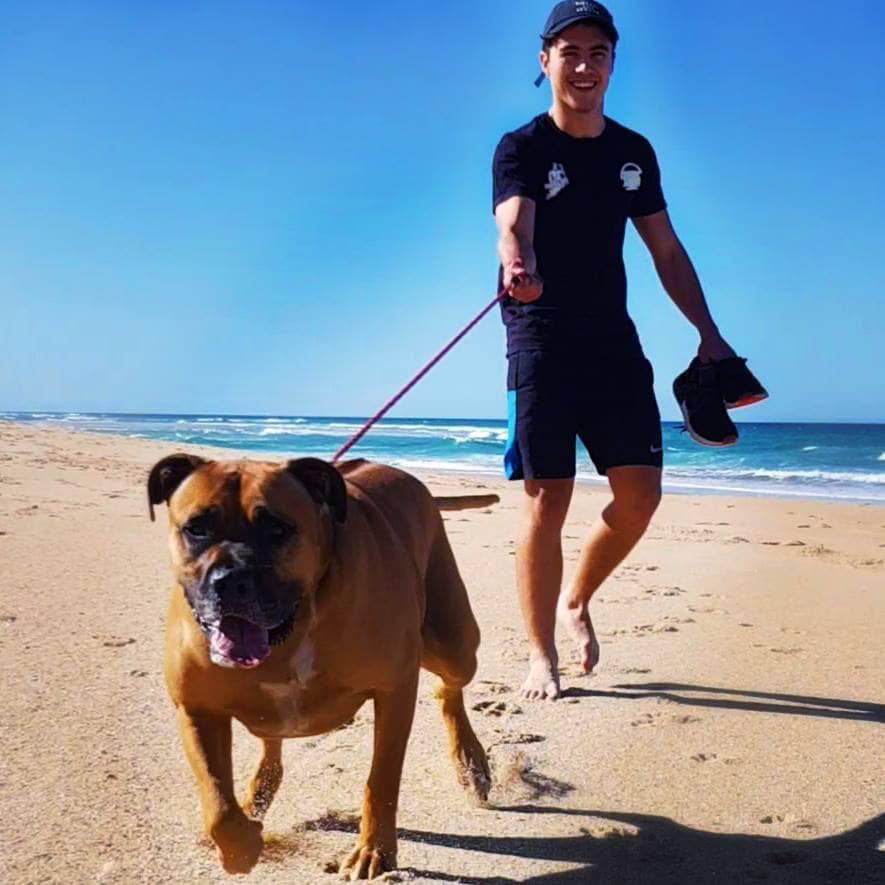 Jarrad Madgwick with dog at beach