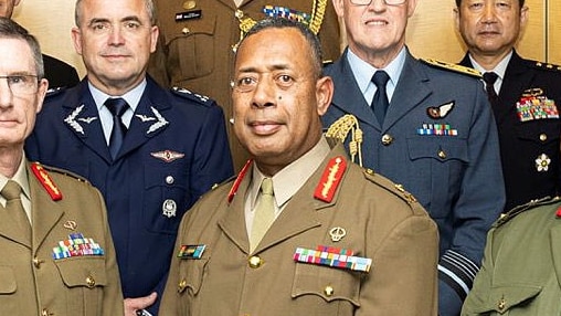 A fijian military commander major general standing among colleagues