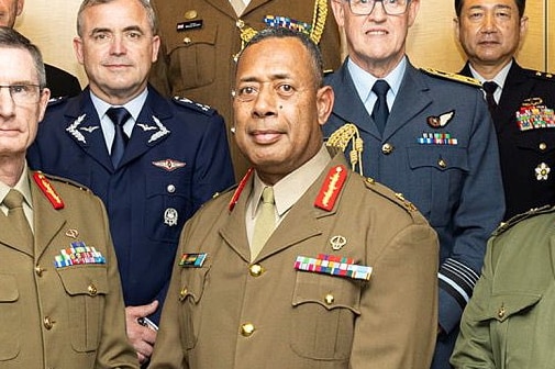 A fijian military commander major general standing among colleagues