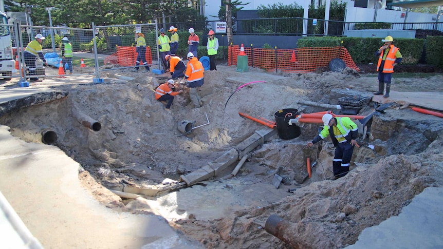 Council workers fixing a sinkhole at Broadbeach.