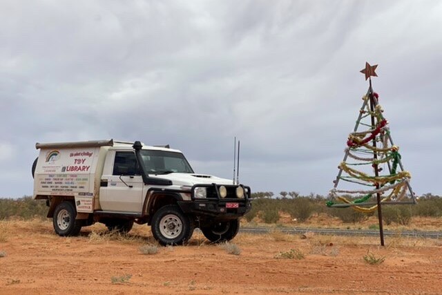 Toy Library car in outback NSW near a Christmas tree.