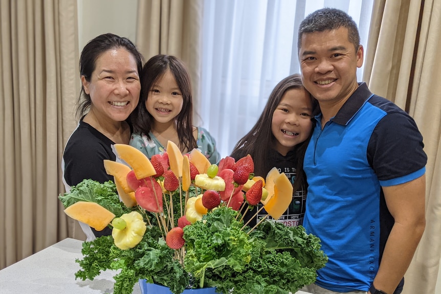 Chi Lam (right) with his wife and two daughters.