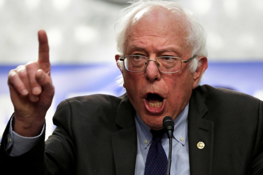Close up image of Bernie Sanders speaking with his index finger raised in the air
