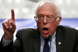Close up image of Bernie Sanders speaking with his index finger raised in the air