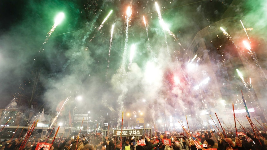 New Years protesters in Seoul, South Korea, set off fireworks and call for impeached President Park Geun-hye to step down.