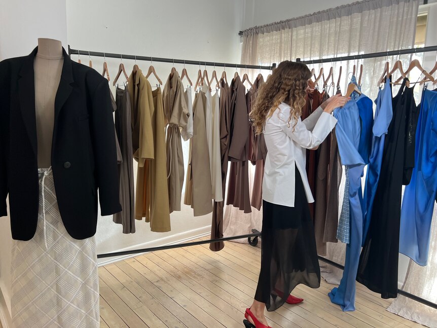 Fashion designer Bianca Spender looks through her new fashion line.