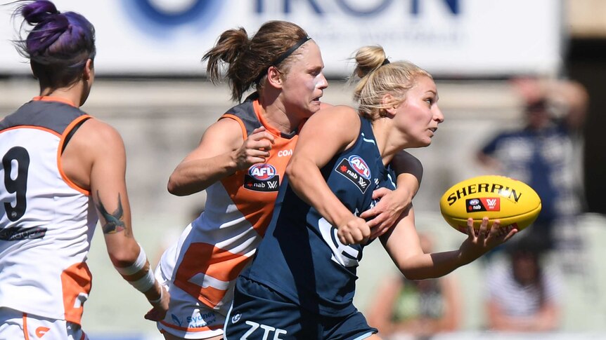 Sarah Hosking handballs under pressure from GWS