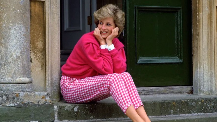 The  late Princess Diana is seen wearing pink gingham trousers and a matching pink fluffy jumper, as she looks left