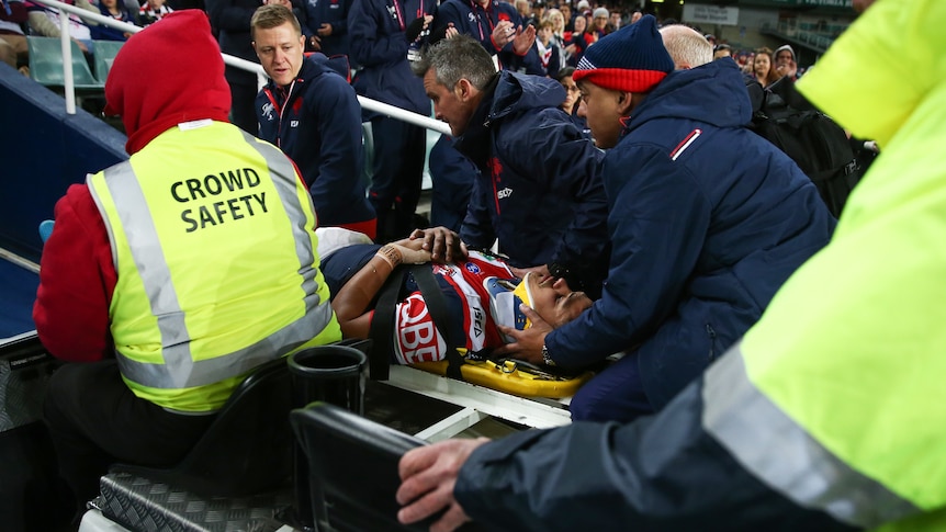 Latrell Mitchell of the Roosters is stretchered off the field against the Penrith Panthers.