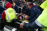 Latrell Mitchell of the Roosters is stretchered off the field against the Penrith Panthers.