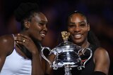 Serena (R) and Venus share a laugh during the Australian Open presentation ceremony.