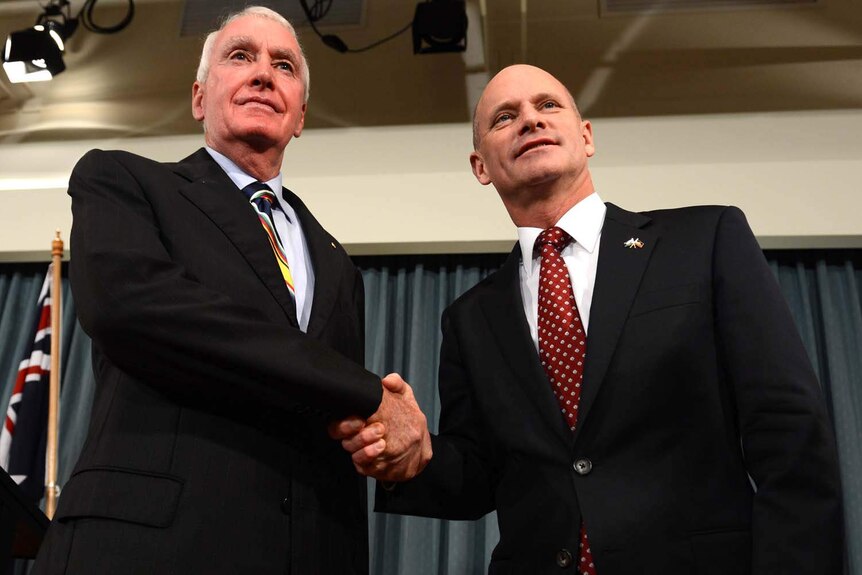 Campbell Newman (right) shakes hands with Richard Chesterman