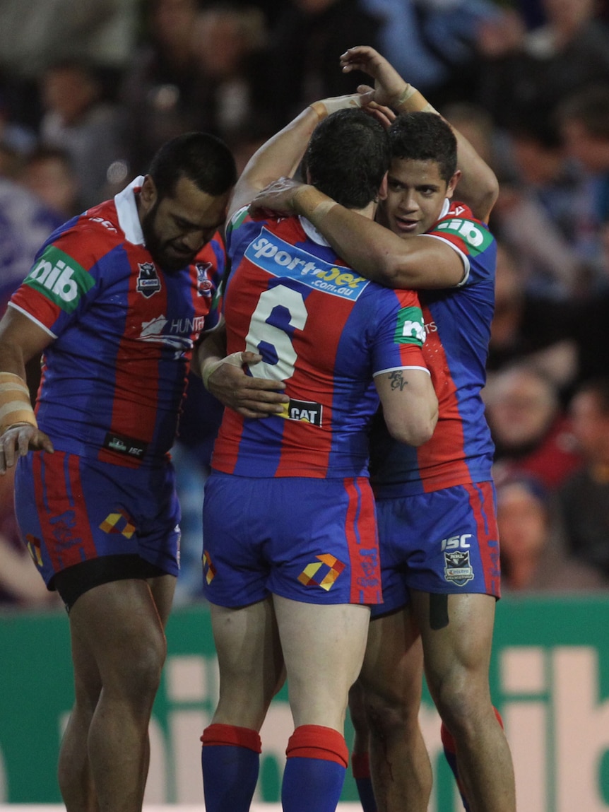 Newcastle's Dane Gagai and Jarrod Mullen (6) celebrate on of the Knight's five tries against Cronulla.