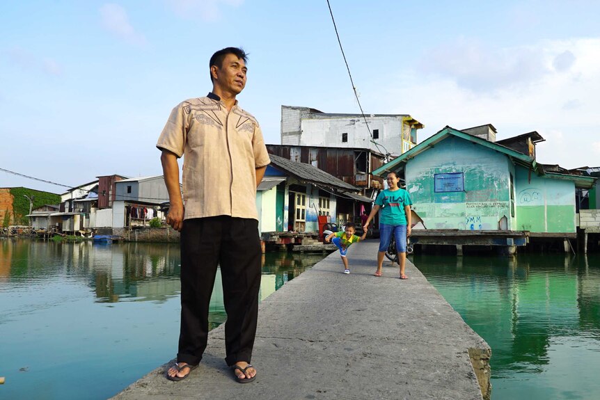 Rudi Suwandi on the walkway into his flooded community in Jakarta