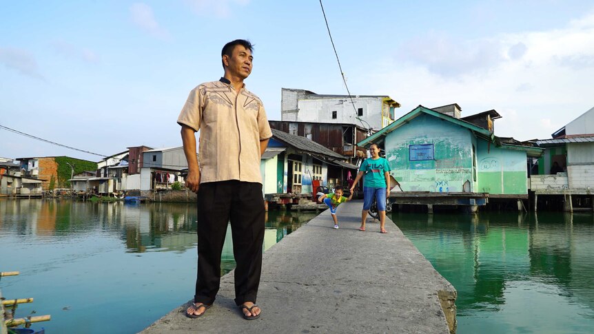 Rudi Suwandi on the walkway into his flooded community in Jakarta