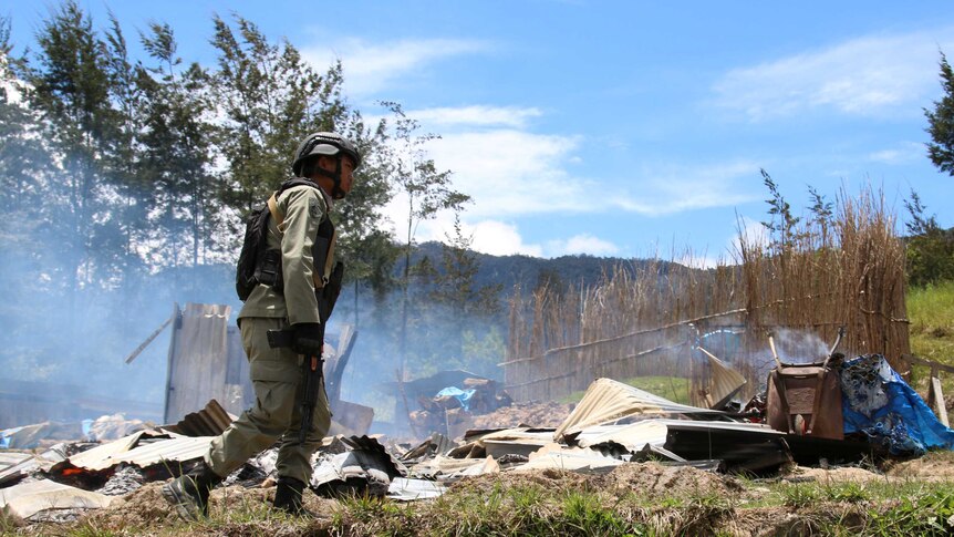 A security officer patrols following a riot in Ilaga, Puncak regency in Papua, Indonesia.
