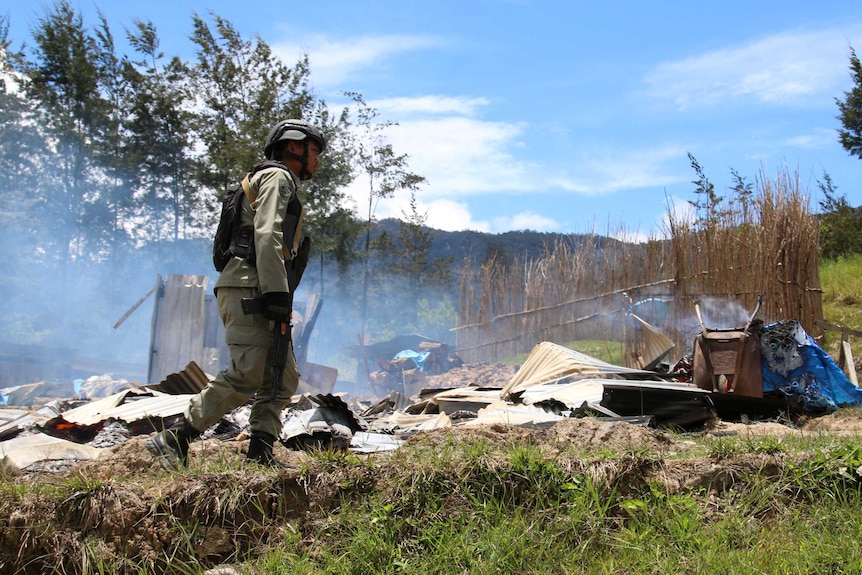 A security officer patrols following a riot in Ilaga, Puncak regency in Papua, Indonesia.