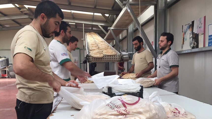 Workers at a Turkish charity make bread.