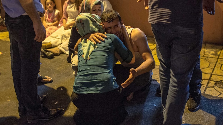 Relatives grieve at hospital following a late night militant attack on a wedding party in Turkey.